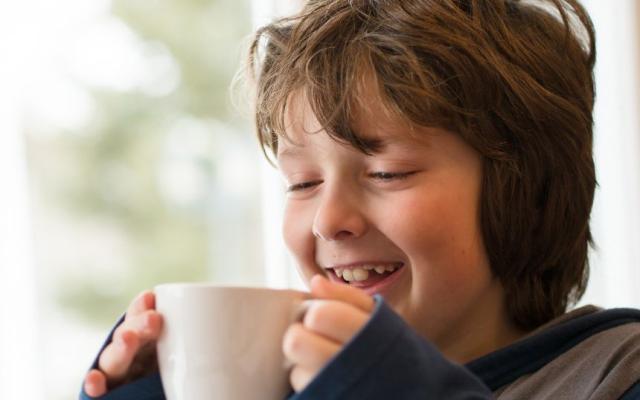 Representing a day in the life of a residential childcare worker - a boy drinking hot chocolate