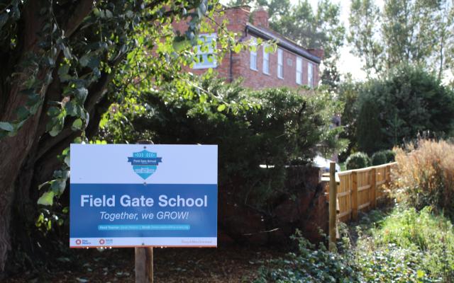 Field gate school sign