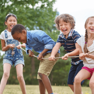 children playing tug of war in a park