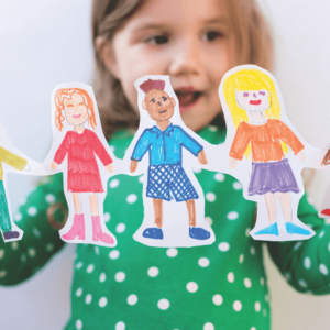 Child holding paper dolls